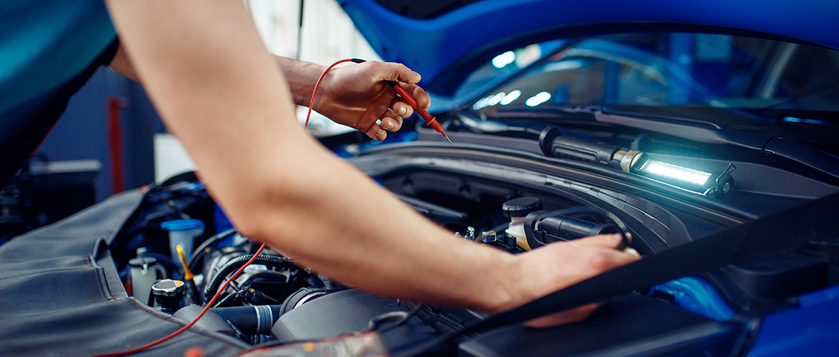 Auto electrician checks electrical circuits